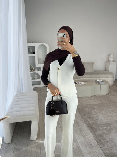 White sleeveless cardigan and trouser set