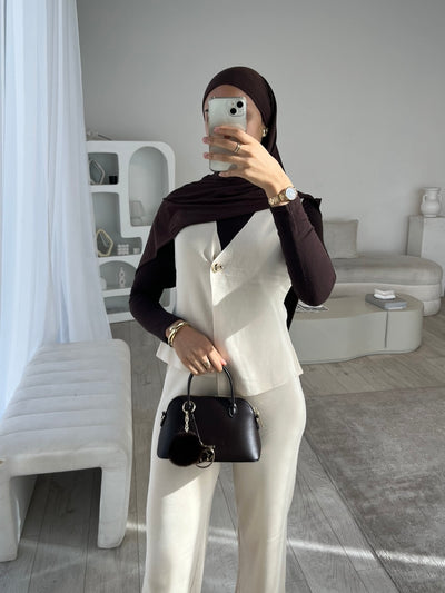 White sleeveless cardigan and trouser set